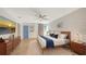 Spacious bedroom with mid-century modern furniture and accent wall at 603 Barnes Pkwy, Nokomis, FL 34275