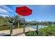 Expansive waterfront dock with red umbrella, perfect for boating at 603 Barnes Pkwy, Nokomis, FL 34275