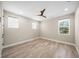 Well-lit bedroom featuring wood-look floors and ceiling fan at 6229 Rivo Lakes Blvd, Sarasota, FL 34241