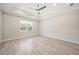 Bright bedroom features wood-look tile floors and shiplap accent wall at 6229 Rivo Lakes Blvd, Sarasota, FL 34241