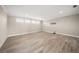 Large bonus room with wood-look floors and window seating at 6229 Rivo Lakes Blvd, Sarasota, FL 34241