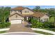 Two-story home with tile roof and landscaping at 6229 Rivo Lakes Blvd, Sarasota, FL 34241