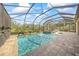 Relaxing pool area with covered patio, plenty of seating and water features at 6229 Rivo Lakes Blvd, Sarasota, FL 34241