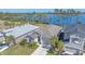 Two homes showcased in an aerial view, one with a lake view and landscaped yard at 6347 Grandview Hill Ct, Bradenton, FL 34203