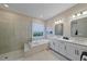 Bright bathroom featuring a glass enclosed shower, a soaking tub, and double sinks at 6347 Grandview Hill Ct, Bradenton, FL 34203