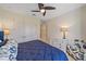 Bedroom featuring closet doors, ceiling fan, plush carpets, and a comfortable chair at 6347 Grandview Hill Ct, Bradenton, FL 34203