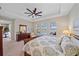 Bedroom with a view of the pool and lake, ceiling fan, and soothing paint colors at 6347 Grandview Hill Ct, Bradenton, FL 34203