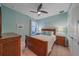 Light blue bedroom with wood bed frame, two nightstands, and ceiling fan at 6347 Grandview Hill Ct, Bradenton, FL 34203