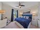 Guest bedroom with a navy blue bed and ceiling fan at 6347 Grandview Hill Ct, Bradenton, FL 34203