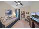 Cozy bedroom with a modern ceiling fan, daybed, study nook, and a decorative television console at 6347 Grandview Hill Ct, Bradenton, FL 34203