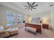 Bright bedroom with three large windows showing pool and lake views; a ceiling fan completes the room at 6347 Grandview Hill Ct, Bradenton, FL 34203