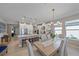 Inviting dining area featuring modern lighting, an open layout, and a view of the kitchen at 6347 Grandview Hill Ct, Bradenton, FL 34203