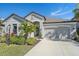 Single-story home with a two-car garage and manicured landscaping at 6347 Grandview Hill Ct, Bradenton, FL 34203