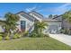 Single-story home with a two-car garage, and nicely landscaped front yard at 6347 Grandview Hill Ct, Bradenton, FL 34203