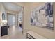 Inviting foyer featuring tiled flooring, a bench, and an abstract painting, leading to the home's entrance at 6347 Grandview Hill Ct, Bradenton, FL 34203