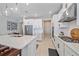 Bright white kitchen with stainless steel appliances and a large island with seating at 6347 Grandview Hill Ct, Bradenton, FL 34203