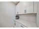 Well-lit kitchenette features white cabinets, quartz countertop, subway tile backsplash, and espresso machine at 6347 Grandview Hill Ct, Bradenton, FL 34203