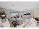 Living room with access to screened-in lanai with lake views, neutral decor and tile floors at 6347 Grandview Hill Ct, Bradenton, FL 34203