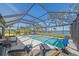 Spacious screened pool with lounge chairs and lake view at 6347 Grandview Hill Ct, Bradenton, FL 34203