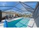 Wide shot of the pool and spa area that is screened in with lounge chairs and an outdoor dining set at 6347 Grandview Hill Ct, Bradenton, FL 34203