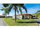 Side view of a house with a privacy fence and tropical landscaping at 6405 Auburn Ave # 8, Bradenton, FL 34207