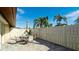 Outdoor patio with table and chairs, surrounded by lush landscaping at 6405 Auburn Ave # 8, Bradenton, FL 34207