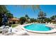 Relaxing community pool with surrounding patio furniture at 6405 Auburn Ave # 8, Bradenton, FL 34207