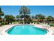 Community swimming pool with plenty of lounge chairs at 6405 Auburn Ave # 8, Bradenton, FL 34207