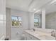 Modern bathroom featuring double vanities, quartz countertops, and a large mirror at 6429 Hollywood Blvd, Sarasota, FL 34231