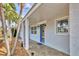 Inviting front entry with a blue door and tiled patio at 6429 Hollywood Blvd, Sarasota, FL 34231