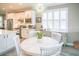 Kitchen with white cabinets and a round dining table at 6730 Haverhill Ct, Bradenton, FL 34202