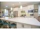 Modern kitchen with white cabinets, quartz countertops and island at 6730 Haverhill Ct, Bradenton, FL 34202