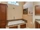 Bathroom with granite-top soaking tub and wood cabinets at 6790 Paseo Castille, Sarasota, FL 34238