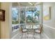 Kitchen breakfast nook with view of the pool and lush landscaping at 6790 Paseo Castille, Sarasota, FL 34238