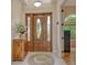 Entryway with a wooden cabinet and a circular rug at 6790 Paseo Castille, Sarasota, FL 34238