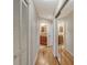 Long hallway with wood floors and mirrored closet doors at 6790 Paseo Castille, Sarasota, FL 34238