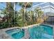 Relaxing screened pool and spa with surrounding landscaping at 6790 Paseo Castille, Sarasota, FL 34238