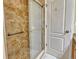 Walk-in shower with tile surround and grab bars at 6790 Paseo Castille, Sarasota, FL 34238