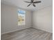 Spacious bedroom with large window and wood-look flooring at 7041 Alan Blvd, Punta Gorda, FL 33982