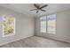 Bedroom with large windows, wood-look floors, and ceiling fan at 7041 Alan Blvd, Punta Gorda, FL 33982