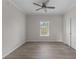 Bright bedroom featuring wood-look floors and a window with blinds at 7041 Alan Blvd, Punta Gorda, FL 33982