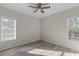 Well-lit bedroom with two windows and wood-look floors at 7041 Alan Blvd, Punta Gorda, FL 33982