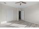 Bedroom with wood-look floors, ceiling fan, and sliding door closet at 7041 Alan Blvd, Punta Gorda, FL 33982