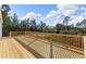 Wooden deck with wooden railings overlooking a wooded area at 7041 Alan Blvd, Punta Gorda, FL 33982