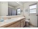 Clean bathroom with shower/tub combo and updated vanity at 7117 Queen Palm Cir, Sarasota, FL 34243