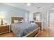 Bright bedroom with a queen-size bed and wood-look floors at 7117 Queen Palm Cir, Sarasota, FL 34243