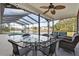 Relaxing screened patio with seating area and lake view at 7117 Queen Palm Cir, Sarasota, FL 34243