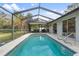 Inviting screened-in pool with patio furniture at 7117 Queen Palm Cir, Sarasota, FL 34243