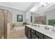 Bathroom features double vanity, large mirror, garden tub, and separate shower at 7123 Marsh View Terrace Ter, Bradenton, FL 34212