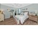 Light and airy bedroom with wood floors, a queen-size bed, and en-suite bathroom at 7123 Marsh View Terrace Ter, Bradenton, FL 34212